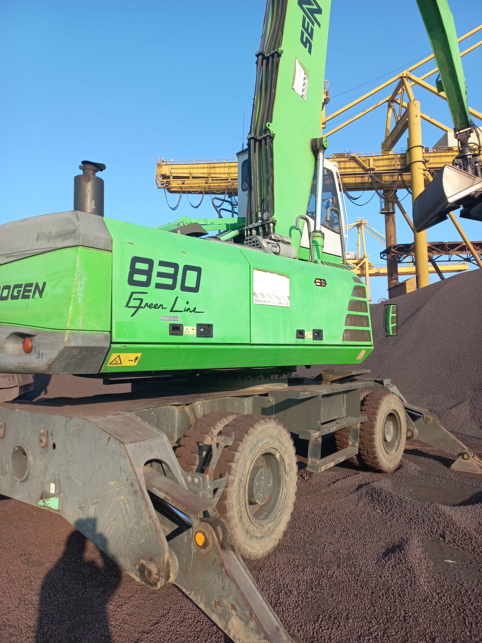 Sennebogen handler loading cargo on barge