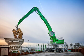 Sennebogen handler loading cargo on barge